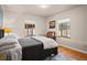Cozy bedroom with hardwood floors, natural light, and a comfortable bed with soft linens at 1545 Locust St, Denver, CO 80220