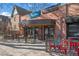 Exterior view of a building with a modern design, featuring multiple businesses and street-side seating at 1545 Locust St, Denver, CO 80220