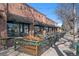 Outdoor seating area with cozy benches and green garland, in front of Bistro Vendome at 1545 Locust St, Denver, CO 80220