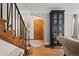 Foyer featuring hardwood floors, a staircase with iron railings, and a dark cabinet, creating a welcoming entry space at 1545 Locust St, Denver, CO 80220