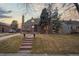 Charming brick home featuring a landscaped front yard, stone steps, and a welcoming entrance at 1545 Locust St, Denver, CO 80220