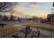 Inviting front porch features wrought iron furniture, ideal for enjoying the neighborhood views during sunset at 1545 Locust St, Denver, CO 80220