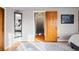 Hallway leading into the bedroom with a door open and hardwood floors with a gray carpet at 1545 Locust St, Denver, CO 80220