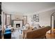 Cozy living room featuring a fireplace, plush seating, a glass coffee table, and natural light from multiple windows at 1545 Locust St, Denver, CO 80220