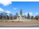 Striking public art with a tiered stone fountain against blue skies and dormant trees at 1545 Locust St, Denver, CO 80220