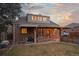 Charming brick home with covered porch and backyard with well maintained lawn, and inviting exterior for outdoor entertaining at 1545 Locust St, Denver, CO 80220