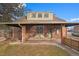 Charming brick home with covered porch, updated windows, a well maintained lawn, and an inviting exterior at 1545 Locust St, Denver, CO 80220