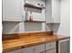 Stylish wet bar area featuring custom cabinetry, floating shelves, and beverage fridge at 1545 Locust St, Denver, CO 80220