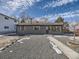 Gray exterior boasts a modern design, landscaping, and a spacious gravel driveway at 4035 S Hazel Ct, Englewood, CO 80110