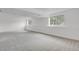 Finished basement with gray carpet, light walls, and natural light from the two windows at 4883 W 68Th Ave # 3, Westminster, CO 80030