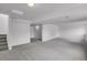 View of the finished basement, showing the light gray carpet, stairs and access to additional unfinished space at 4883 W 68Th Ave # 3, Westminster, CO 80030