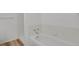 Clean bathroom with white tub and shower combo and wood-look flooring at 4883 W 68Th Ave # 3, Westminster, CO 80030