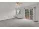 Sunlit bedroom with sliding glass doors leading to a private balcony and plush carpeting at 4883 W 68Th Ave # 3, Westminster, CO 80030