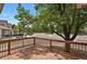 View from the wooden deck showing neighborhood street with mature trees and surrounding landscaping at 4883 W 68Th Ave # 3, Westminster, CO 80030