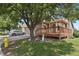 Exterior view of home featuring a two-car garage and a cozy wooden deck with stairs at 4883 W 68Th Ave # 3, Westminster, CO 80030