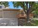 Charming exterior of home featuring a two-car garage and a cozy wooden deck with stairs at 4883 W 68Th Ave # 3, Westminster, CO 80030