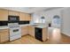 Open kitchen featuring wood cabinets, white appliances and view to living room at 4883 W 68Th Ave # 3, Westminster, CO 80030