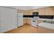 Functional kitchen featuring wood cabinets, white appliances and hardwood floors at 4883 W 68Th Ave # 3, Westminster, CO 80030