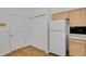 Well-lit kitchen featuring matching white appliances, cabinets, and adjacent pantry at 4883 W 68Th Ave # 3, Westminster, CO 80030