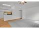 Spacious living room featuring neutral walls, carpet and adjacent kitchen at 4883 W 68Th Ave # 3, Westminster, CO 80030