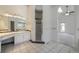 Bathroom with dual sink vanity, walk-in shower, and an entrance to the main bedroom at 1535 Longview Cir, Monument, CO 80132