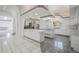 This kitchen features stainless steel appliances, white cabinetry, and an open layout with granite countertops at 1535 Longview Cir, Monument, CO 80132