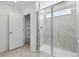 Modern bathroom with a tiled shower and a glass door, next to a shelved linen closet at 16618 W 92Nd Pl, Arvada, CO 80007