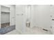 Bright bathroom featuring a toilet, towel rack, and marble tile floors at 16618 W 92Nd Pl, Arvada, CO 80007