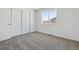 Bedroom featuring neutral carpet, slider closet door, and natural light at 16618 W 92Nd Pl, Arvada, CO 80007
