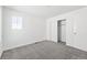 Bedroom featuring neutral carpet, closet, and a window at 16618 W 92Nd Pl, Arvada, CO 80007