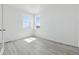 Bright and sunny bedroom with white walls, two windows, and light hardwood flooring at 16618 W 92Nd Pl, Arvada, CO 80007