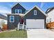 Charming two-story home features a red door, white garage, and modern architectural design at 16618 W 92Nd Pl, Arvada, CO 80007