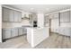 Modern kitchen featuring an island, stainless steel appliances, and gray cabinets at 16618 W 92Nd Pl, Arvada, CO 80007