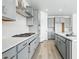 Close up of kitchen with stove, stainless steel appliances, gray cabinets, and plenty of storage at 16618 W 92Nd Pl, Arvada, CO 80007