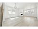 Bright and airy living room featuring large windows, hardwood floors, and a cozy fireplace at 16618 W 92Nd Pl, Arvada, CO 80007