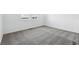 Spacious room featuring neutral carpeting, bright white walls, and two large windows at 16618 W 92Nd Pl, Arvada, CO 80007