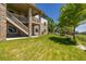Well-maintained backyard with lush green lawn, landscaping, and stone accents, perfect for outdoor enjoyment at 27565 E Nova Pl, Aurora, CO 80016