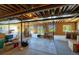 Unfinished basement offers a blank canvas with natural light from windows and door to the yard at 27565 E Nova Pl, Aurora, CO 80016