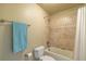 Bathroom showcasing a shower-over-tub combination, a neutral palette and tiled surround at 27565 E Nova Pl, Aurora, CO 80016