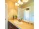 Bathroom featuring a vanity with stone countertops, a sink and a large mirror at 27565 E Nova Pl, Aurora, CO 80016