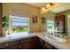 Bathroom with a scenic backyard view, a vanity with stone countertops and and sinks at 27565 E Nova Pl, Aurora, CO 80016