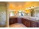 Luxurious bathroom featuring an expansive vanity with and sinks and stone countertops at 27565 E Nova Pl, Aurora, CO 80016