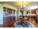 Dining area with built-in cabinetry, hardwood floors, and access to the kitchen at 27565 E Nova Pl, Aurora, CO 80016