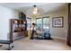 Cozy exercise room featuring workout equipment, natural light, and built-in shelves for storage at 27565 E Nova Pl, Aurora, CO 80016