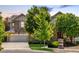 Charming two-story home featuring a stone facade, manicured landscaping, and an attached two-car garage at 27565 E Nova Pl, Aurora, CO 80016