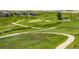 The golf course community is complete with manicured lawns and picturesque walking paths alongside a winding creek at 27565 E Nova Pl, Aurora, CO 80016