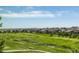 Scenic view showcasing the community's well-manicured golf course and beautiful residences on a sunny day at 27565 E Nova Pl, Aurora, CO 80016