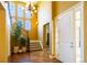 Warm and inviting foyer with high ceilings, hardwood floors, staircase, and large chandelier at 27565 E Nova Pl, Aurora, CO 80016