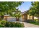 Lovely stone home featuring a three-car garage with an extended driveway and landscaping at 27565 E Nova Pl, Aurora, CO 80016