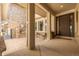 Covered front porch with stone fireplace feature, cozy seating, and a grand entrance at 27565 E Nova Pl, Aurora, CO 80016